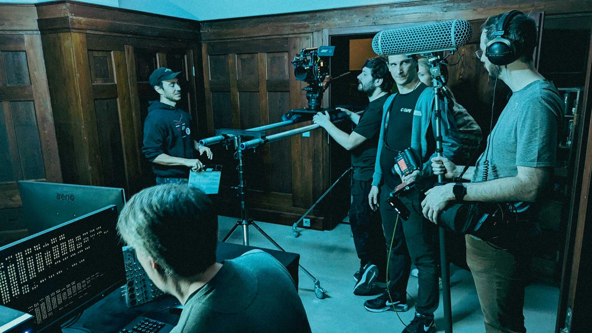 Silver Porsche 911 GT3 racing up a mountain road, motion-blurred asphalt and dramatic cloudscape in the background.