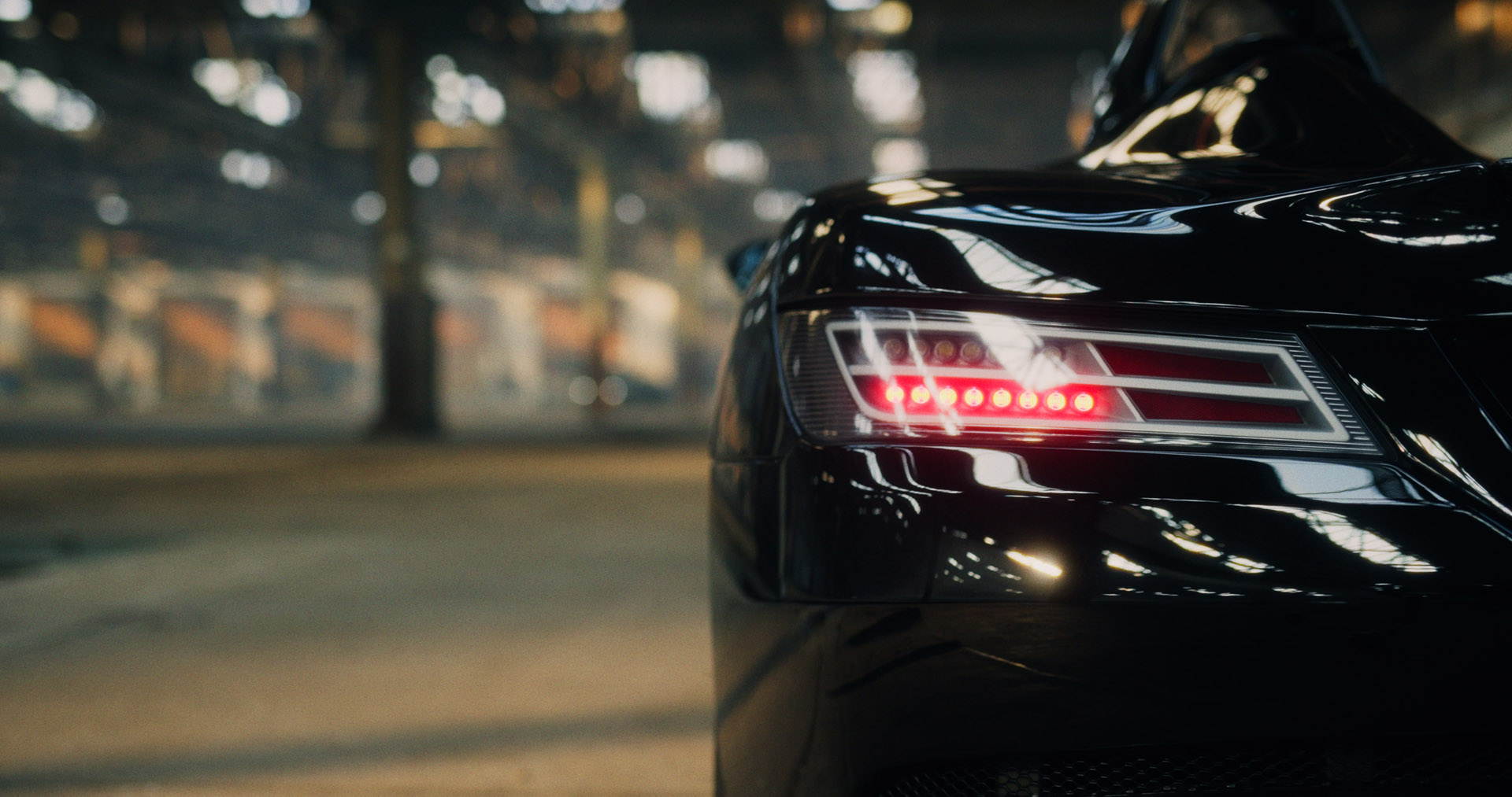 Abstract motion-blur of red and white kerb stripes on dark asphalt, evoking racetrack speed.