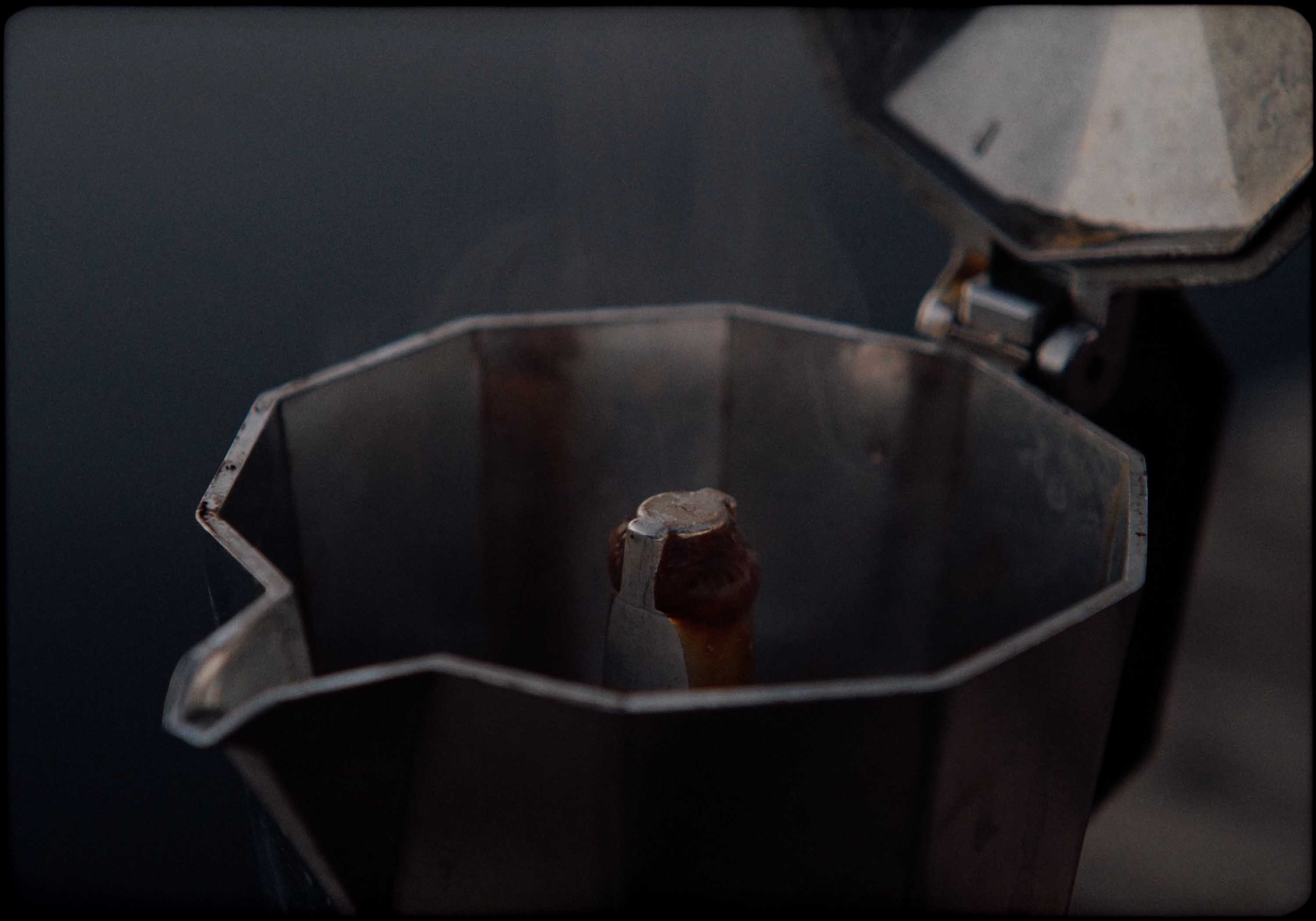Macro detail: red-lit paddle shifter on a steering wheel, silhouetted against dark blue background.